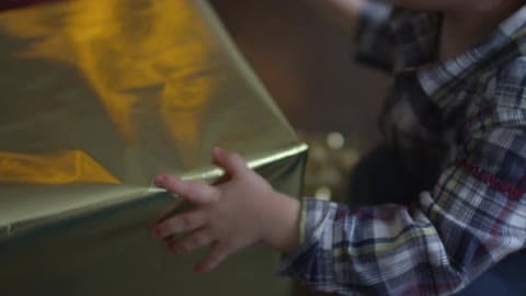 A Boy Sits Down With A Christmas Gift