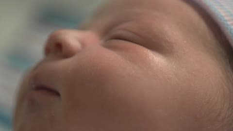 A Newborn Baby Starts To Open Its Eyes