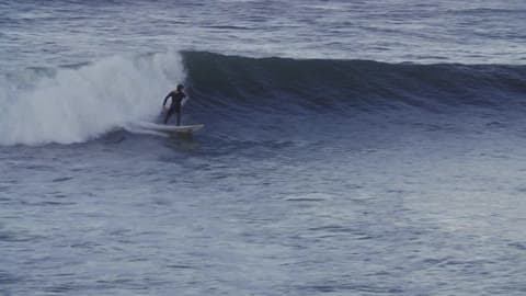 A Person Trying To Catch A Wave
