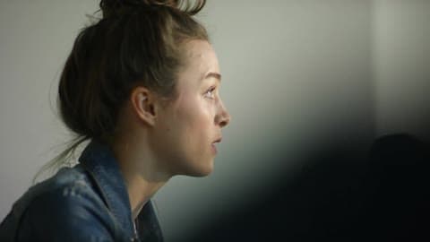 A Person With Their Hair In A Bun