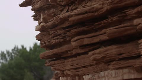 A Rock Formation Near A Forest