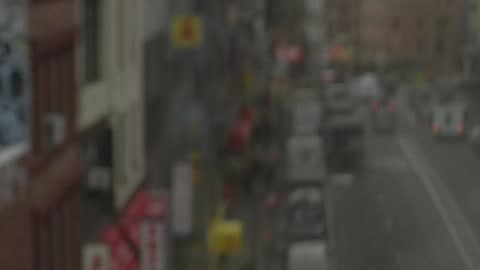 A View Of A City'S Streets And Buildings From An Elevated Train