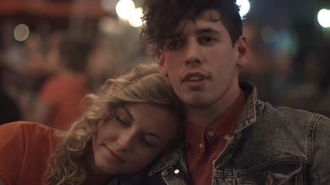 A Woman Lays Her Head On The Shoulder Of A Man