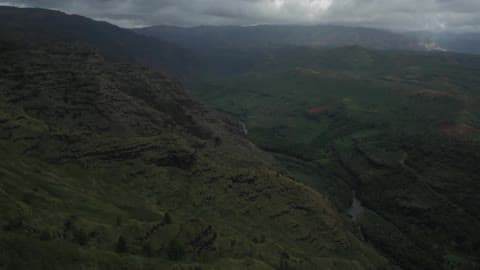 Aerial View Of A Valley Between Mountains Under A Cloudy Sky