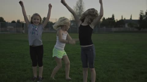 Children Are Playing In A Field