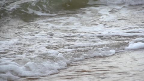 Medium Sized Waves Rolling Into A Beach