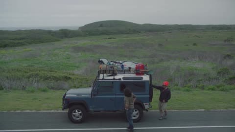 Two Men Get Out Of Their Jeep On The Side Of The Road